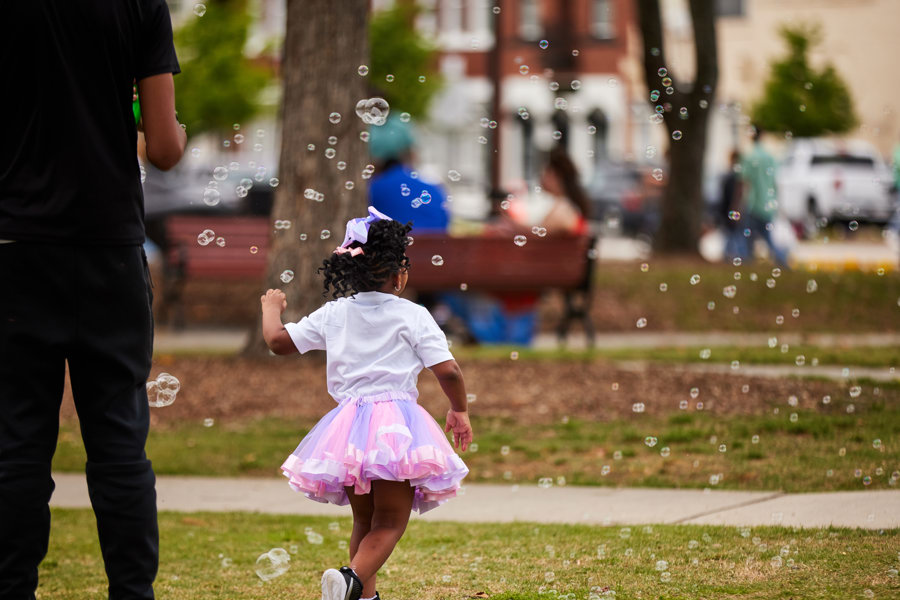 girl running in bubbles